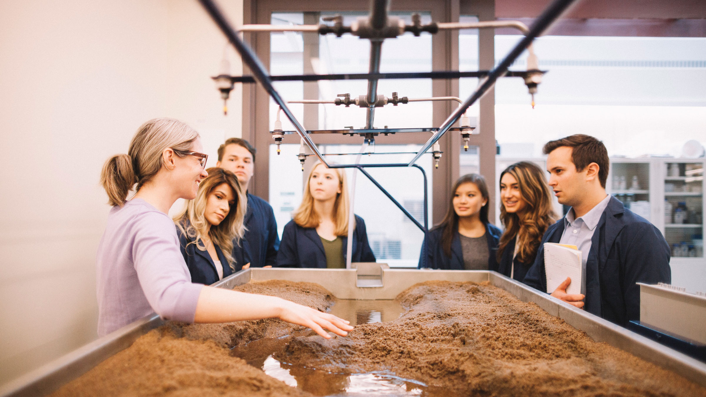 Kimberly DiGiovanni, professor of engineering, talks about civil engineering with students in a soil simulation lab